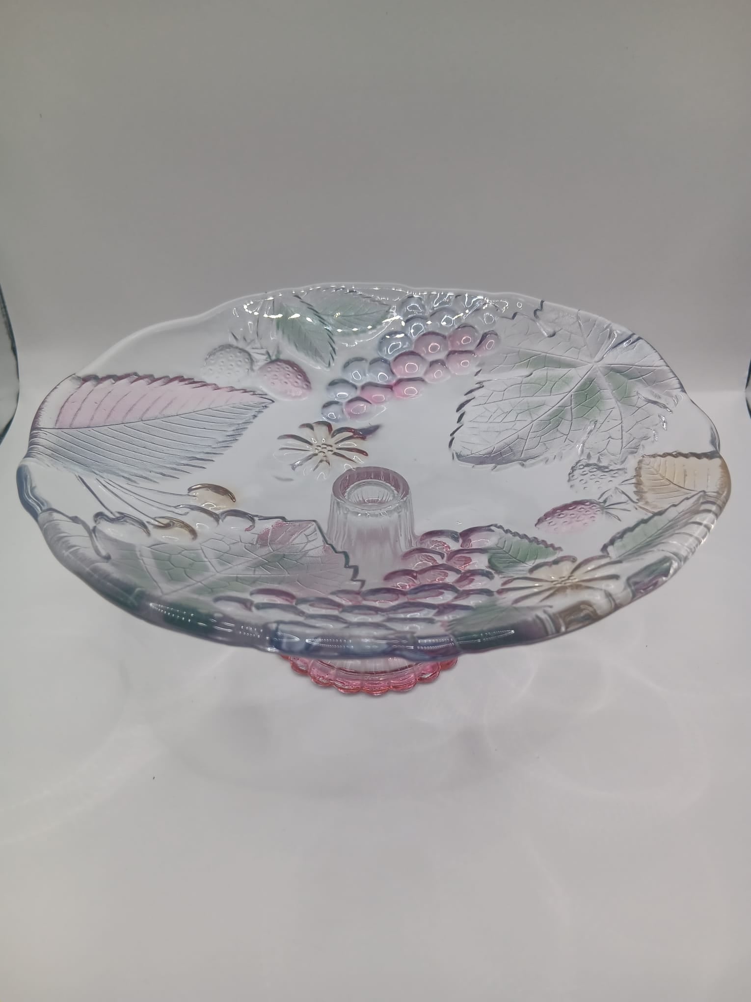 A Glass Fruit Stand on a pedestal with Hints of colour In the Fruit Design