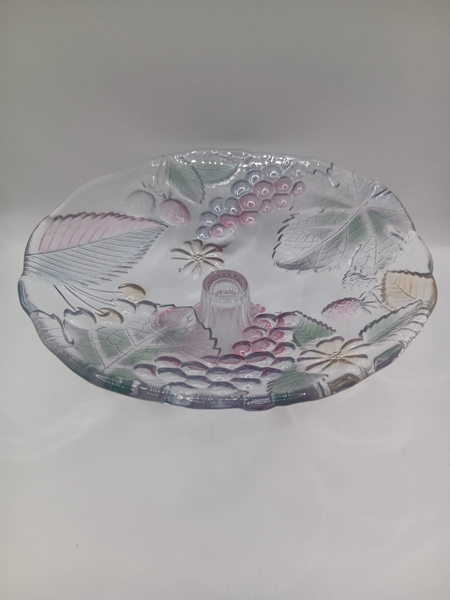 A Glass Fruit Stand on a pedestal with Hints of colour In the Fruit Design