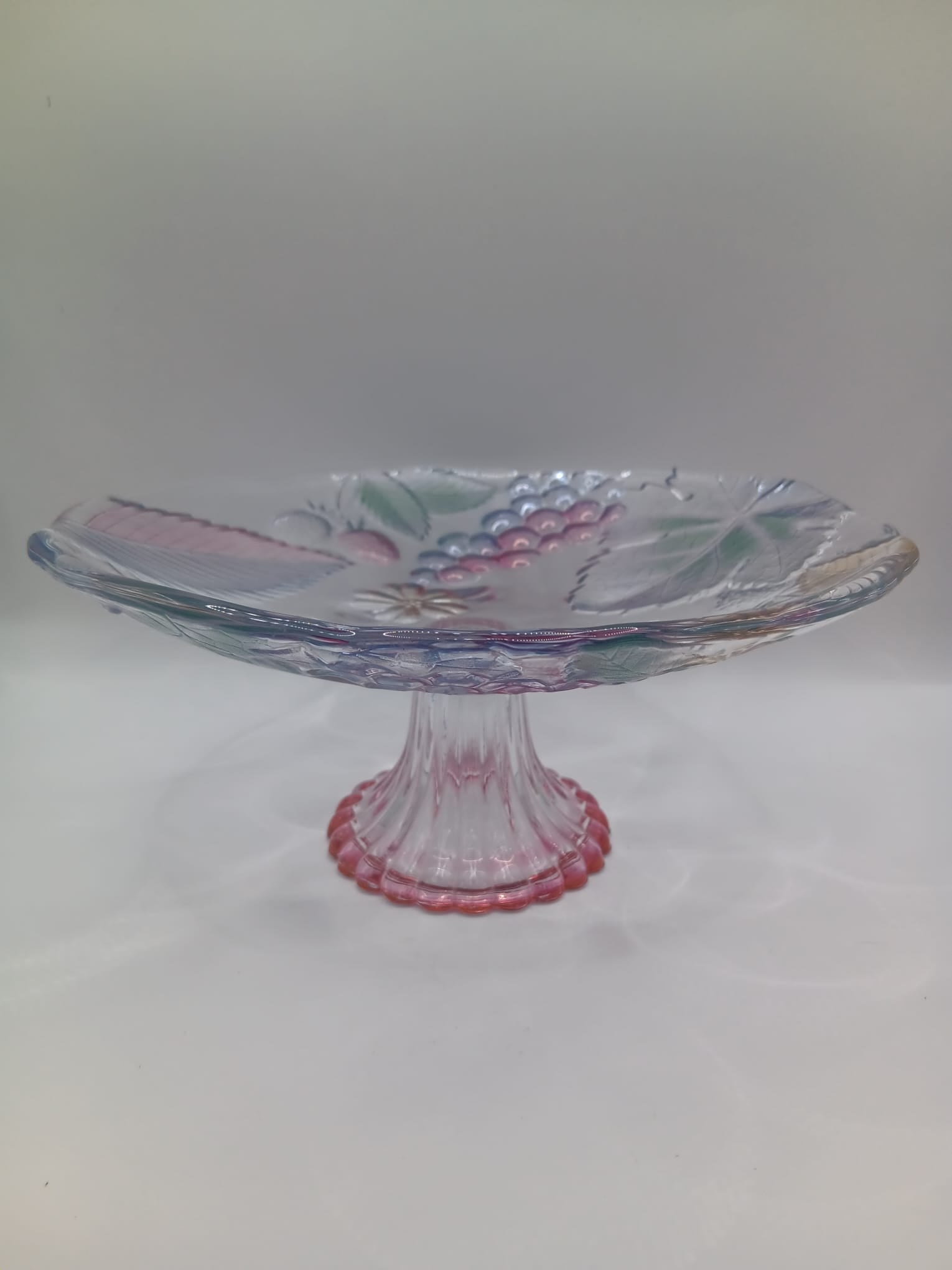 A Glass Fruit Stand on a pedestal with Hints of colour In the Fruit Design