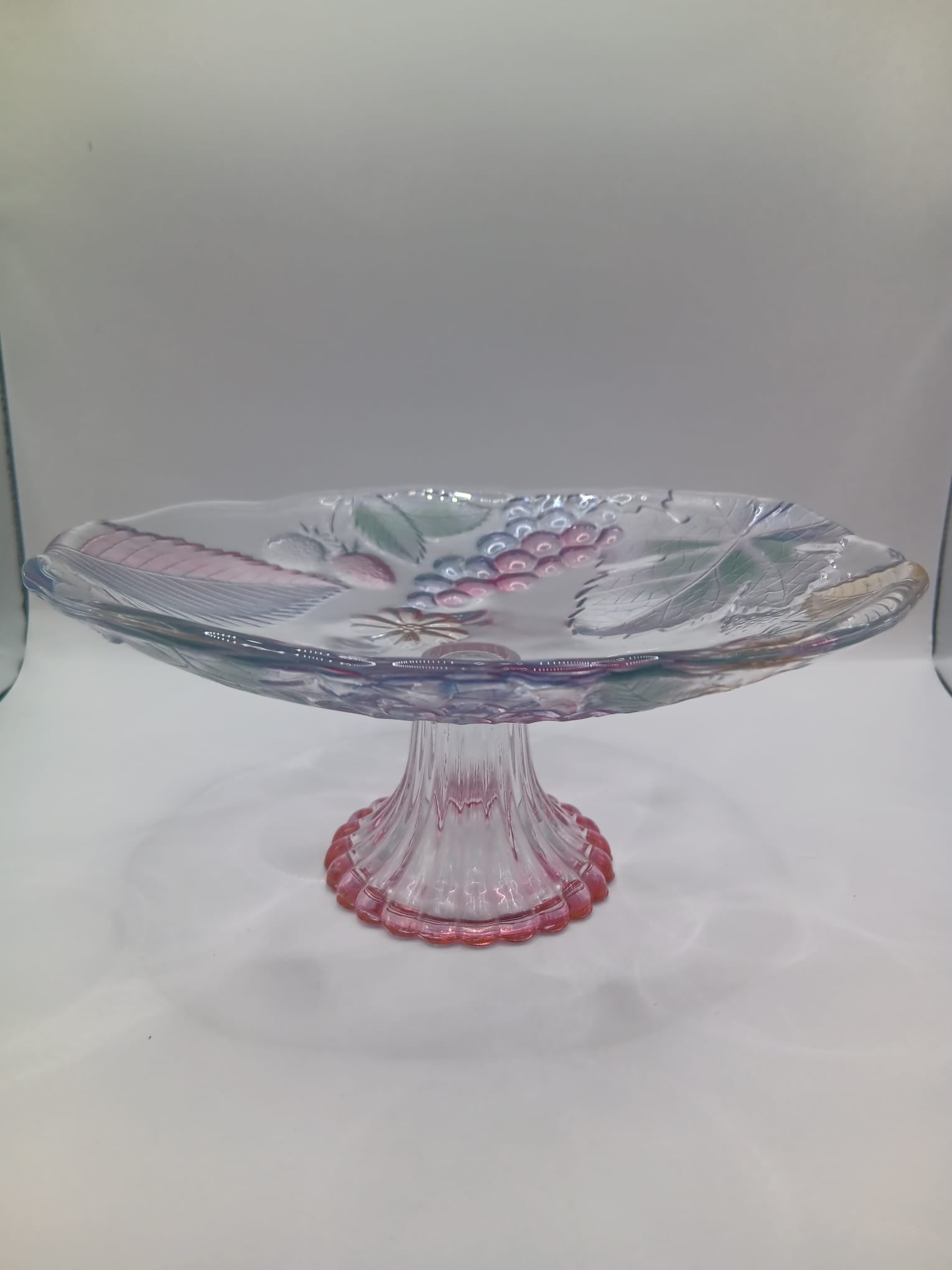 A Glass Fruit Stand on a pedestal with Hints of colour In the Fruit Design
