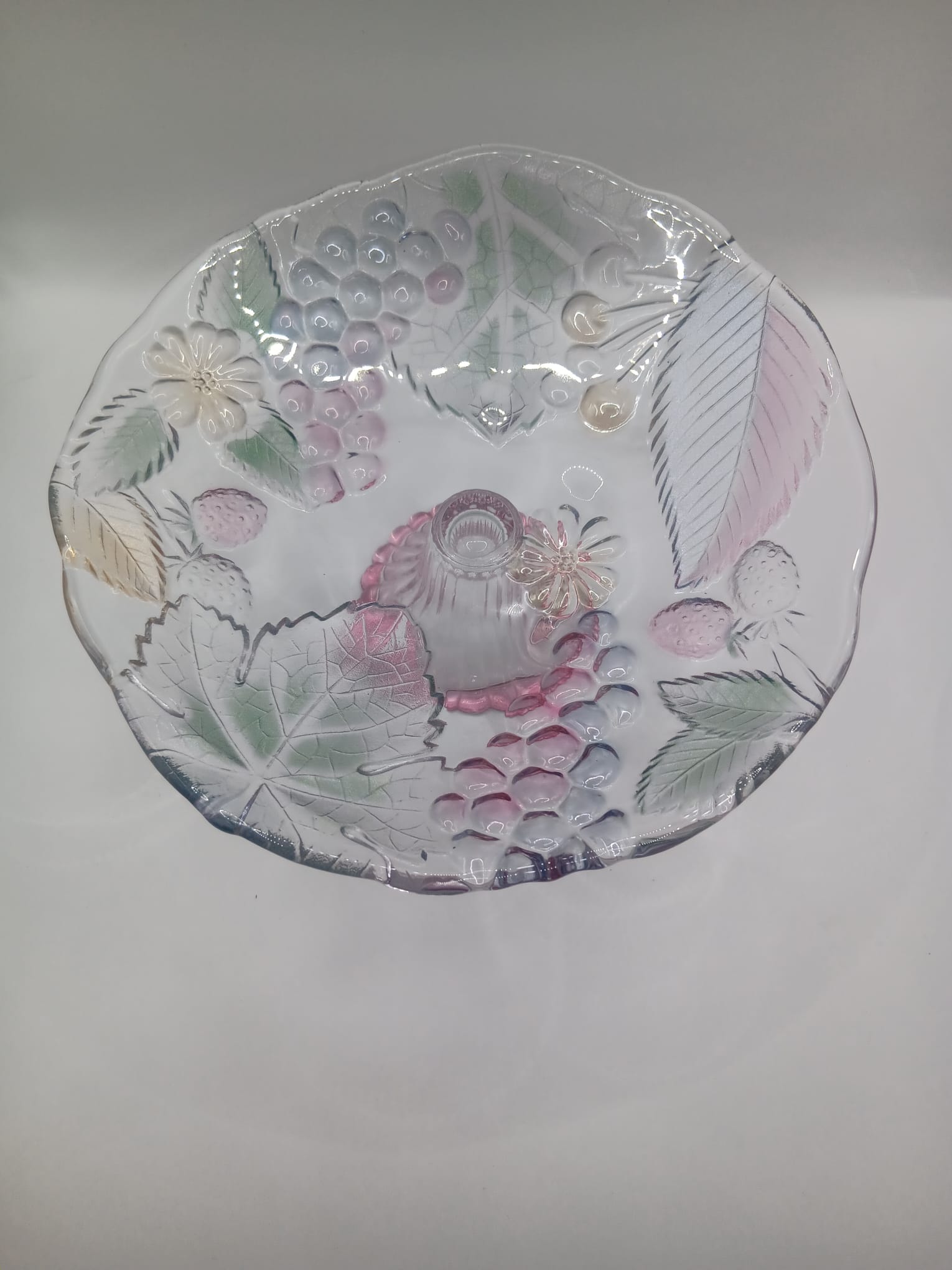A Glass Fruit Stand on a pedestal with Hints of colour In the Fruit Design